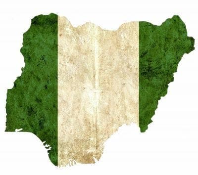 The outline of Nigeria filled with a weathered green-white-green flag.